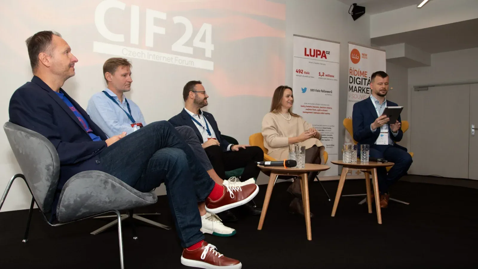 Panel debate I moderated at Czech Internet Forum 2024, four seated panellists and Lupa.cz banners behind them