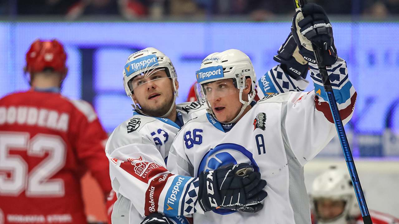 Illustrative photo of the Czech hockey league: two players in white Tipsport jerseys, numbers 52 and 86, celebrating on the ice beside an opponent in red