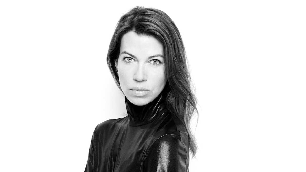 Black-and-white studio portrait of Andrea Běhounková in a black turtleneck against a white background