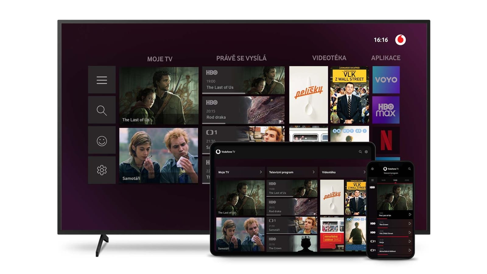 Vodafone TV interface on a TV screen, tablet and phone, with menu tabs Moje TV, Právě se vysílá, Videotéka, Aplikace and tiles for HBO, Voyo, HBO Max and Netflix