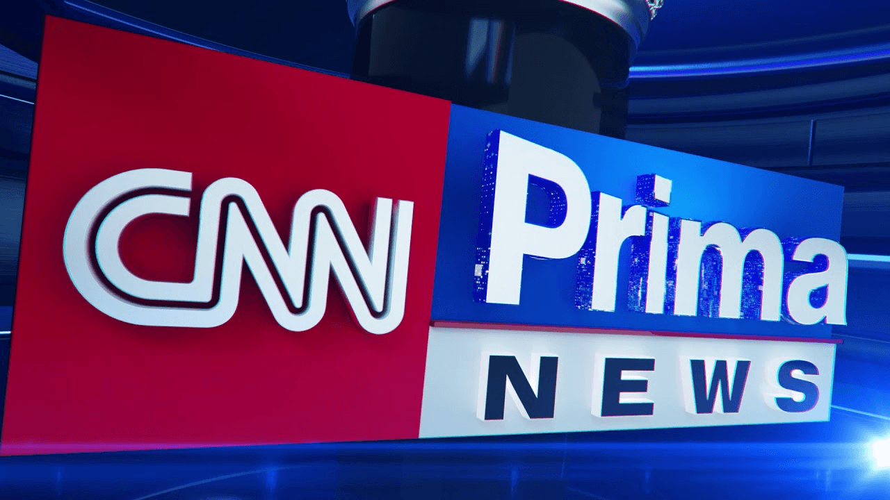 CNN Prima News logo on a red and blue panel in a television studio