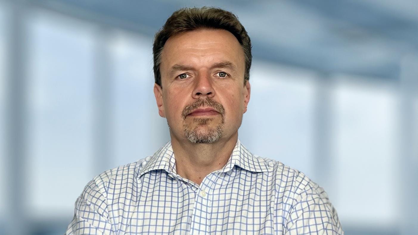 Portrait of Martin Konrád in a checked shirt against a blurred light background